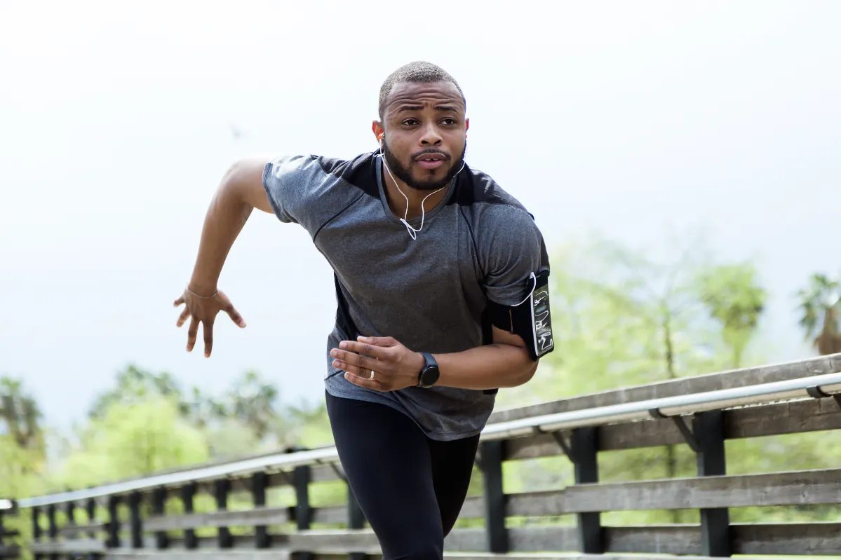 fit and sporty young man running in the city utc