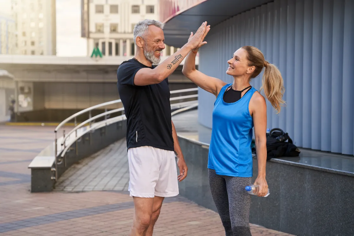 fitness friends high five in an urban setting utc