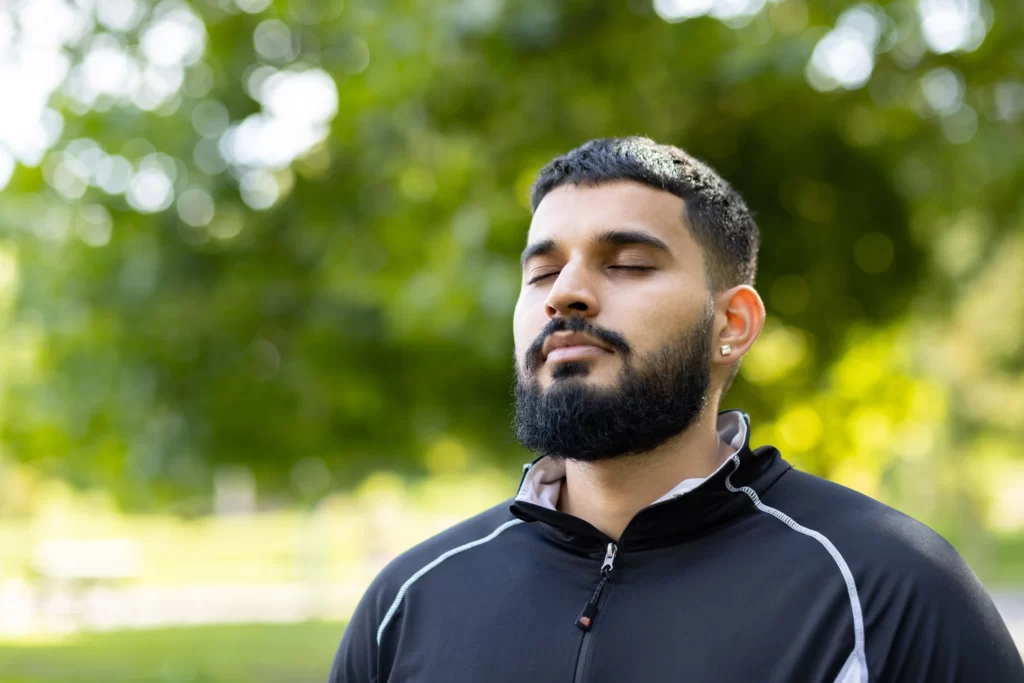 man in contemplation at serene park setting utc