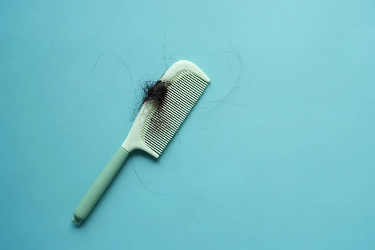 a brush with lost hair on table utc
