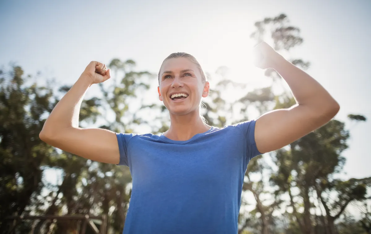active woman cheering in outdoor sunny setting utc