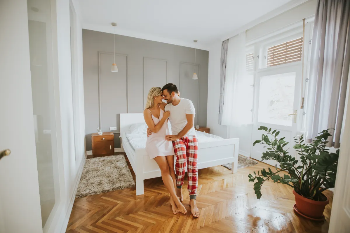 affectionate lovers embracing on bed at home utc