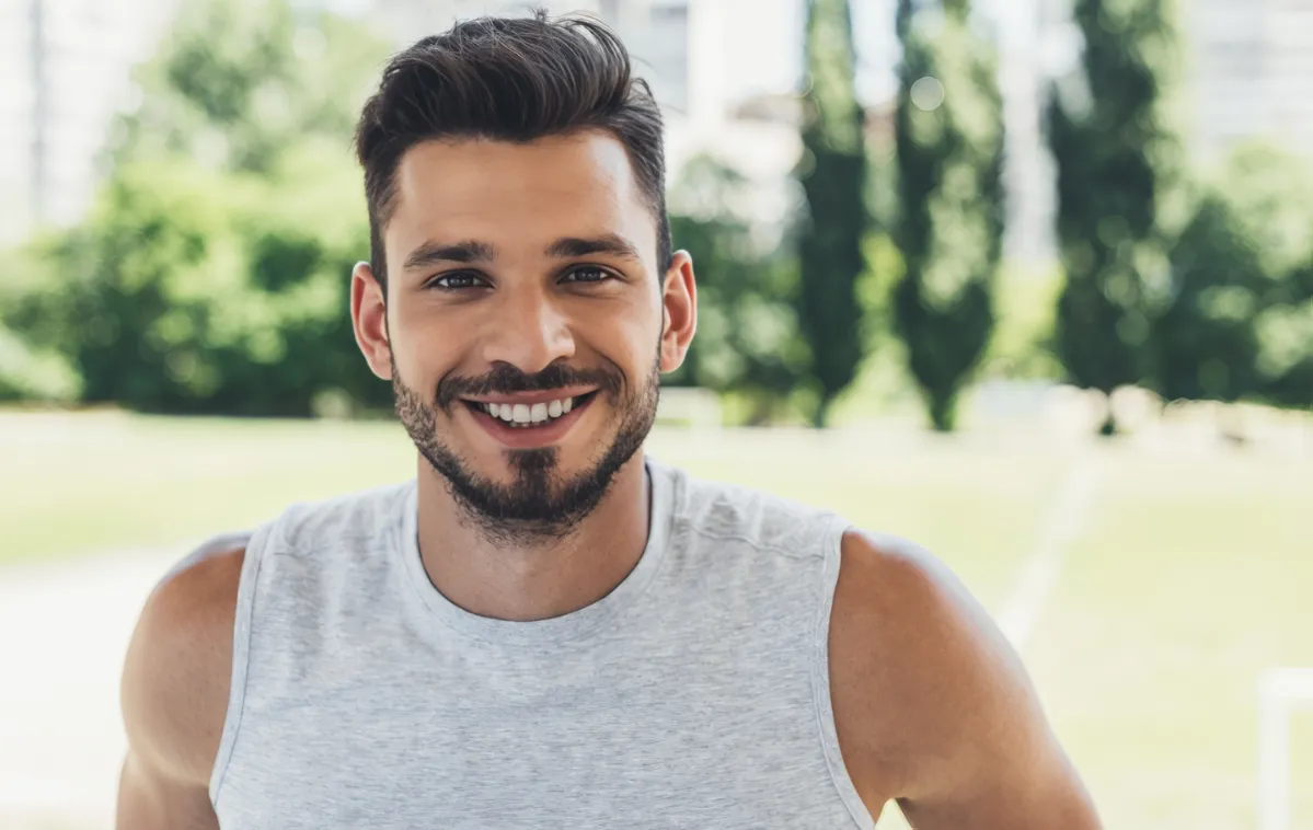 close up shot of smiling young man looking at came utc