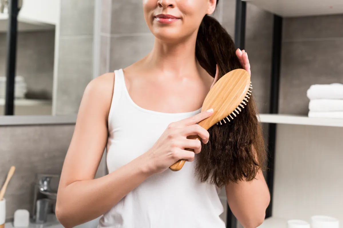 cropped view of smiling brunette woman brushing ha utc