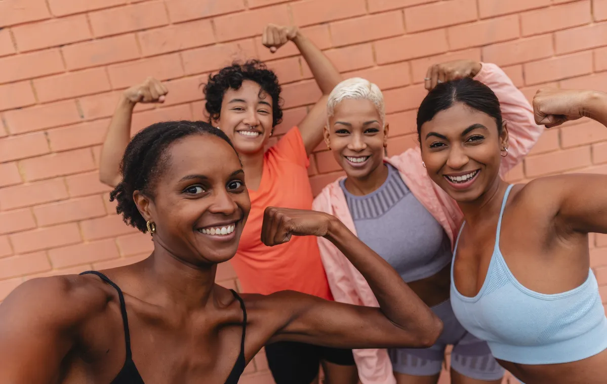 four fit black women showing their biceps after tr utc