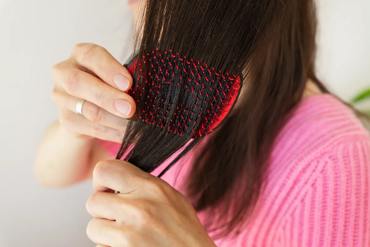 portrait of a radiant girl combing her dark hair utc
