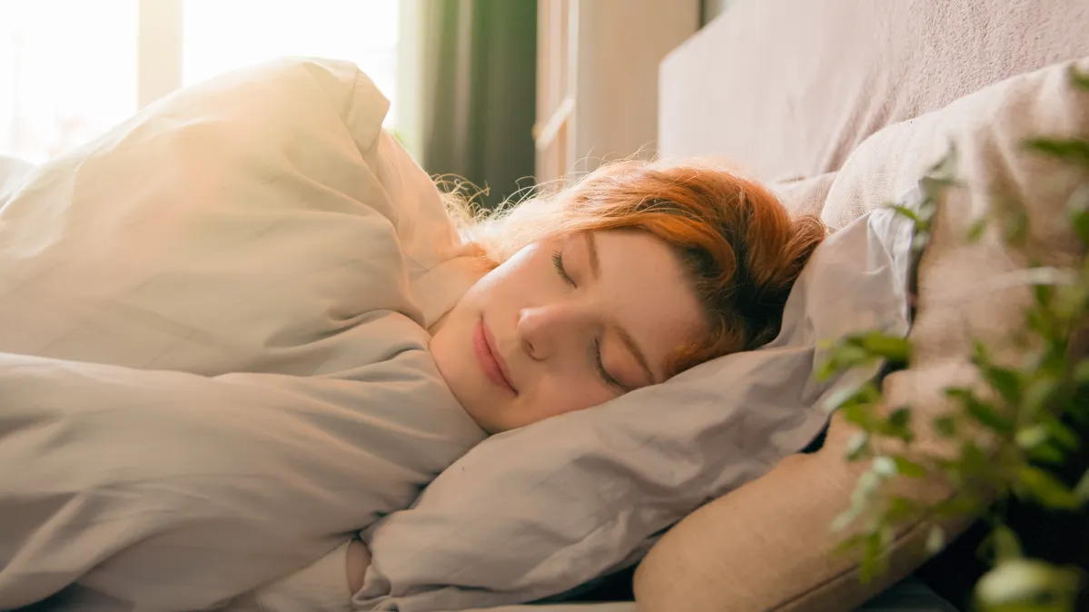 sleepy beautiful woman waking up lying in comforta utc