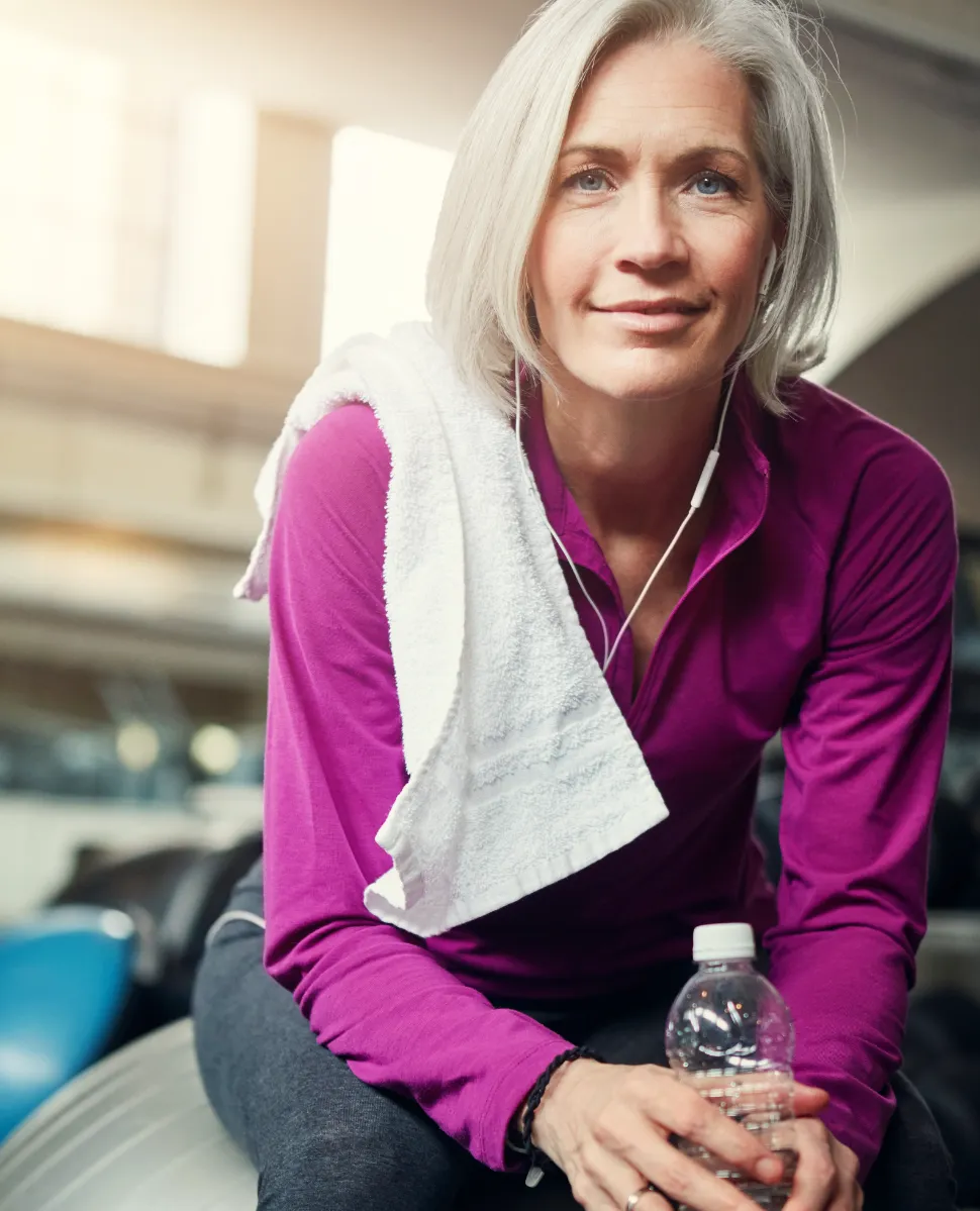 woman resting after exercise in gym setting utc