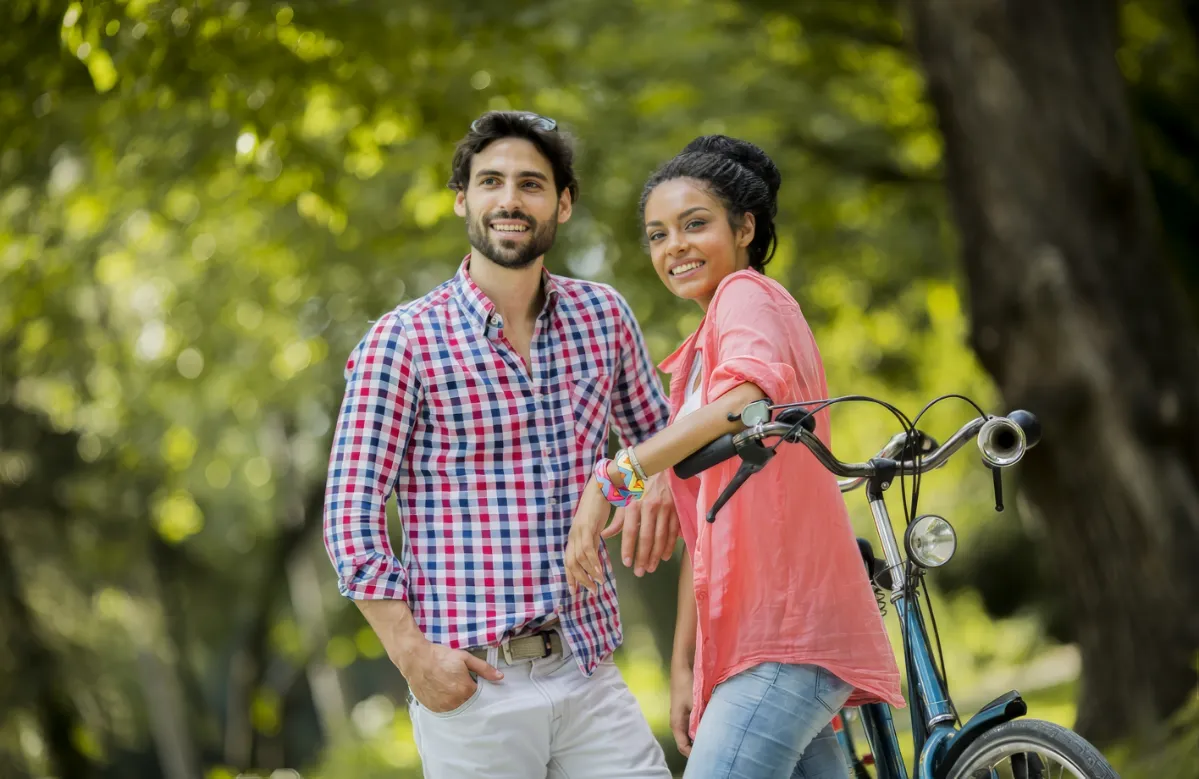 young couple riding on the tandem bicycle utc